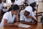 Students from Aga Khan Academy Mombasa and Mbaraki Girls High School work collaboratively on an activity