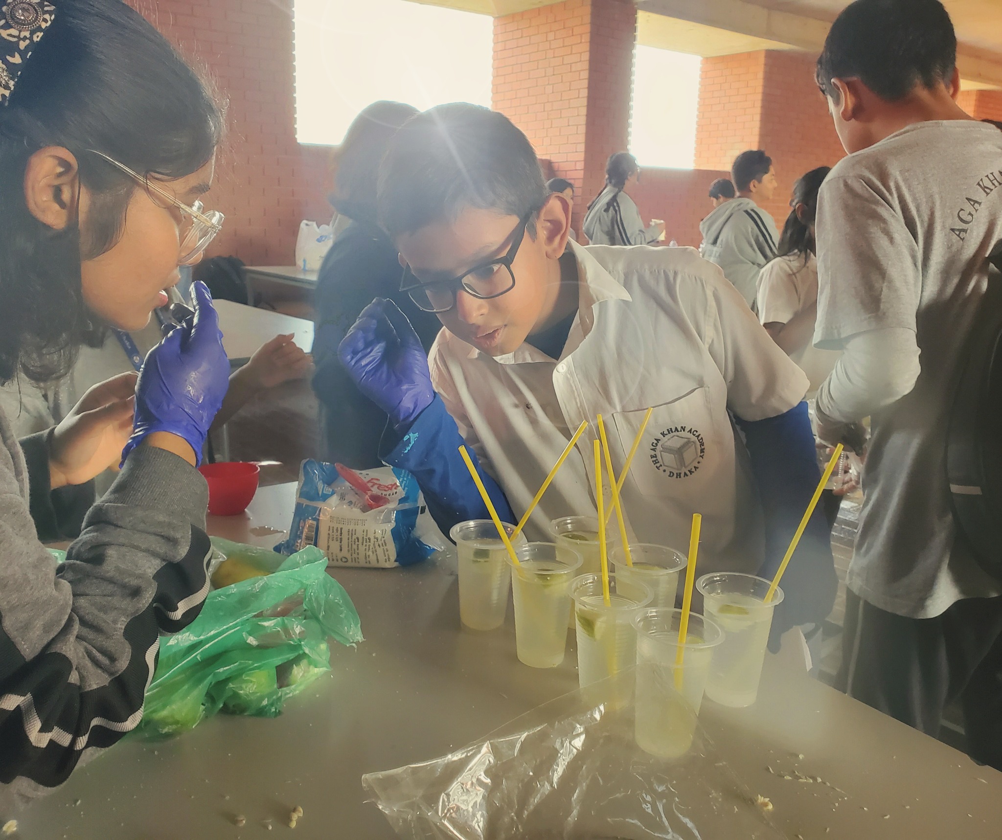 Grade 6 students preparing lemonades to serve the academic support staff