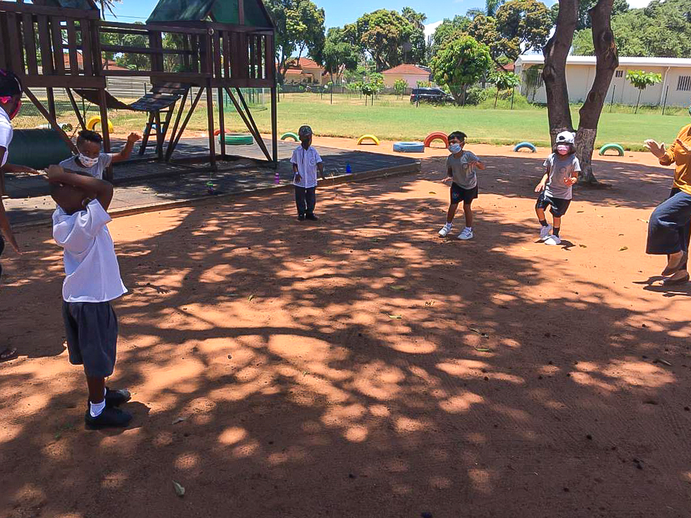 Early Years students playing outside while maintaining their social distance