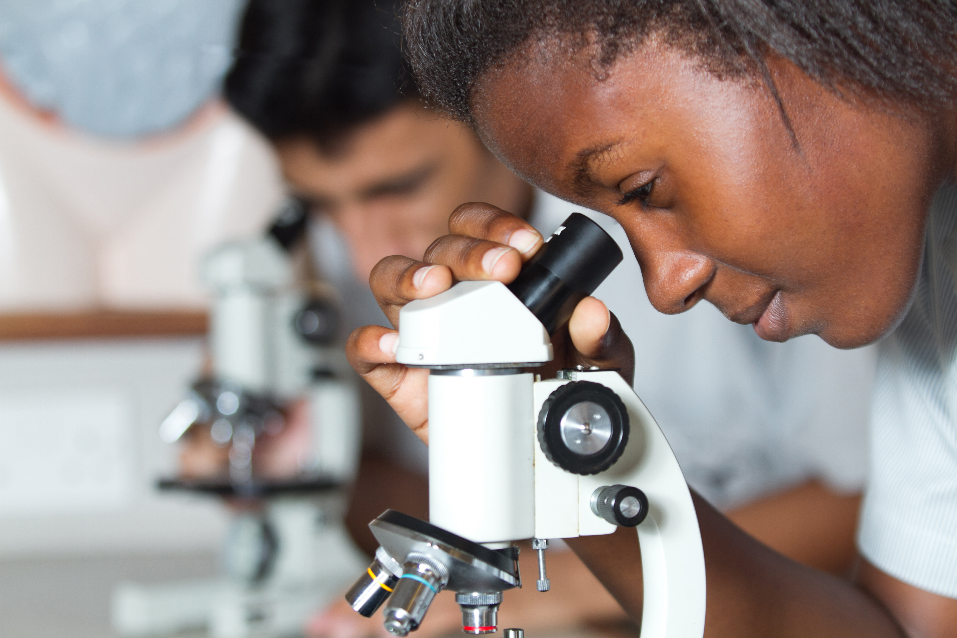 Student looking through microscope