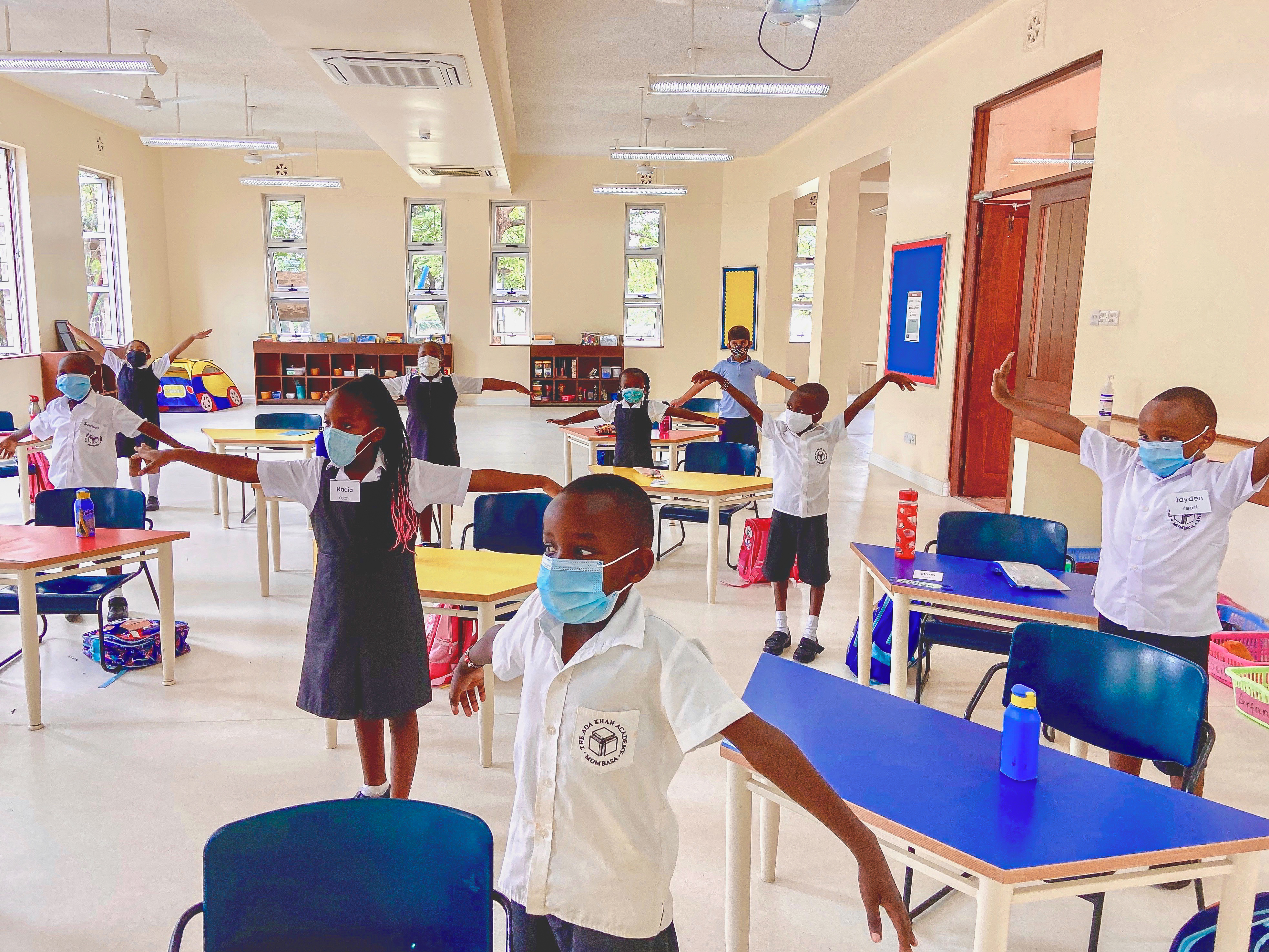 Junior School students having a stretching break while maintaining social distancing