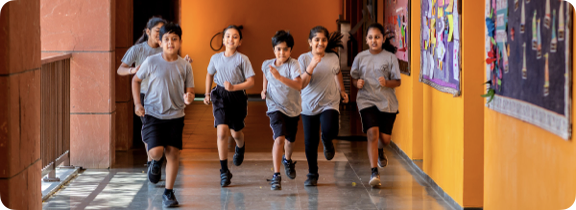 Students running through a corridor