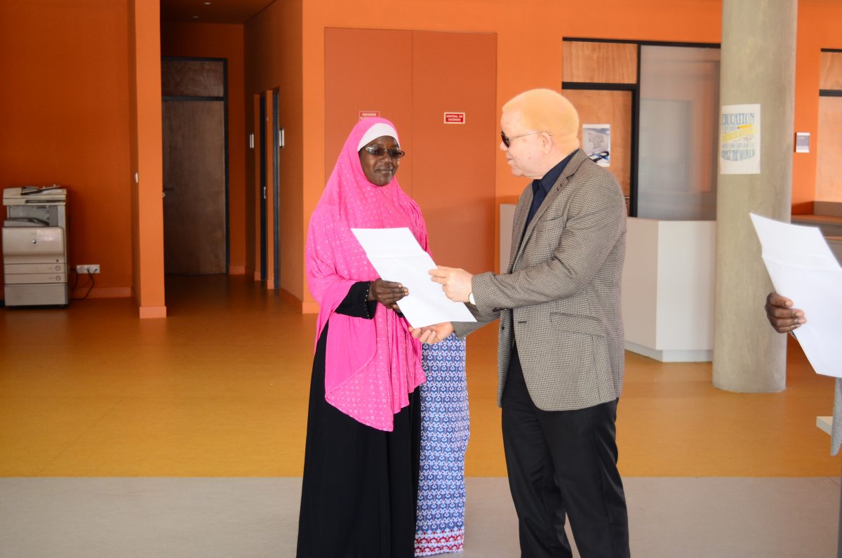 National Director for Teacher Training Dr Remane Selimane awarding certificates to a participant of the School Council Training programme