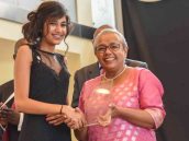 First Lady Margaret Kenyatta presents the female student of the year award to Ruhi Kamal Manek
